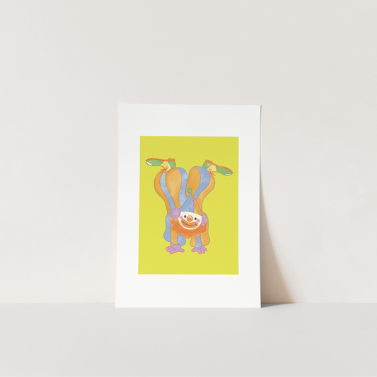 Framed artwork of a colorful clown design on a white surface with a light background