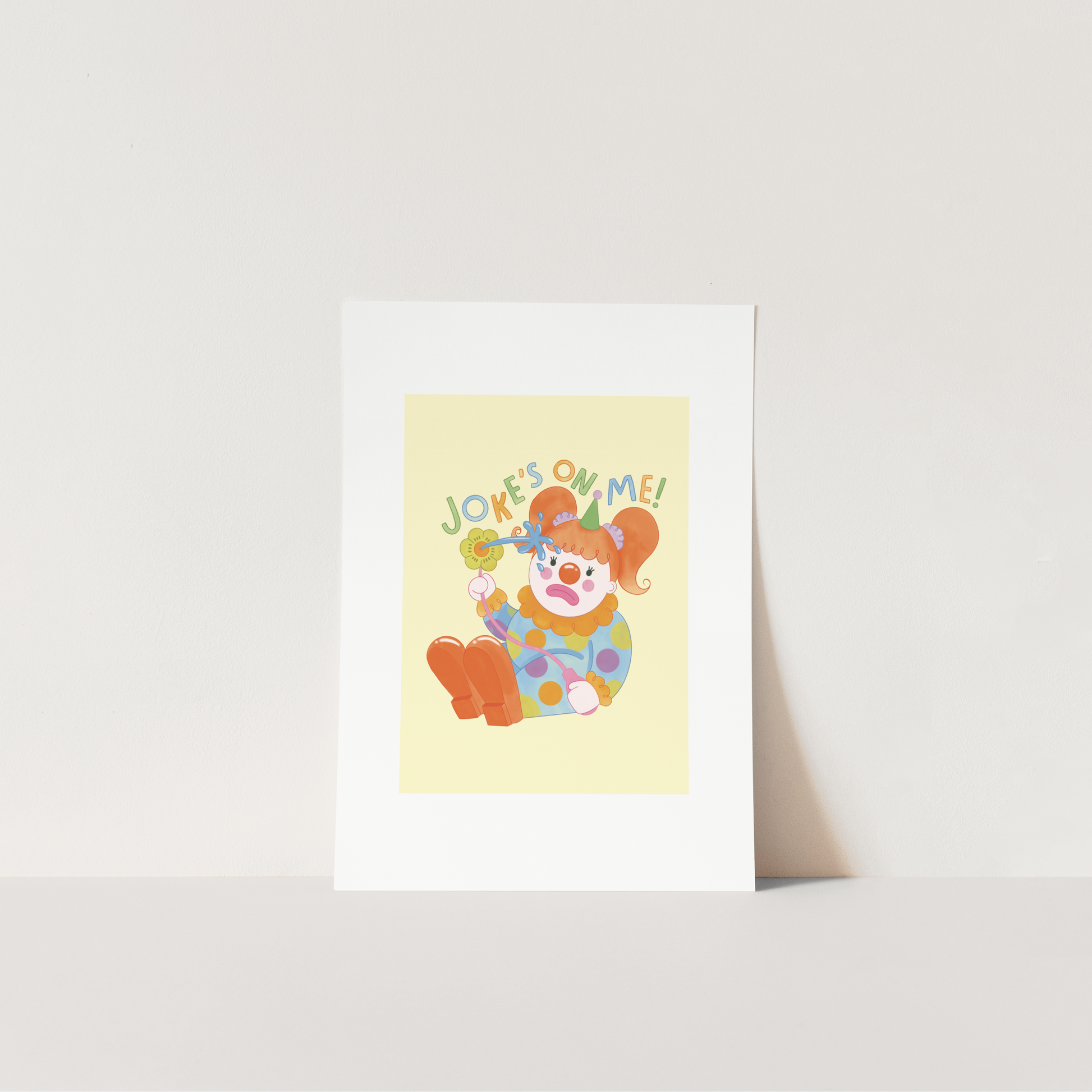 Colorful greeting card with a clown illustration and 'Jokes on me!' text on a white background.